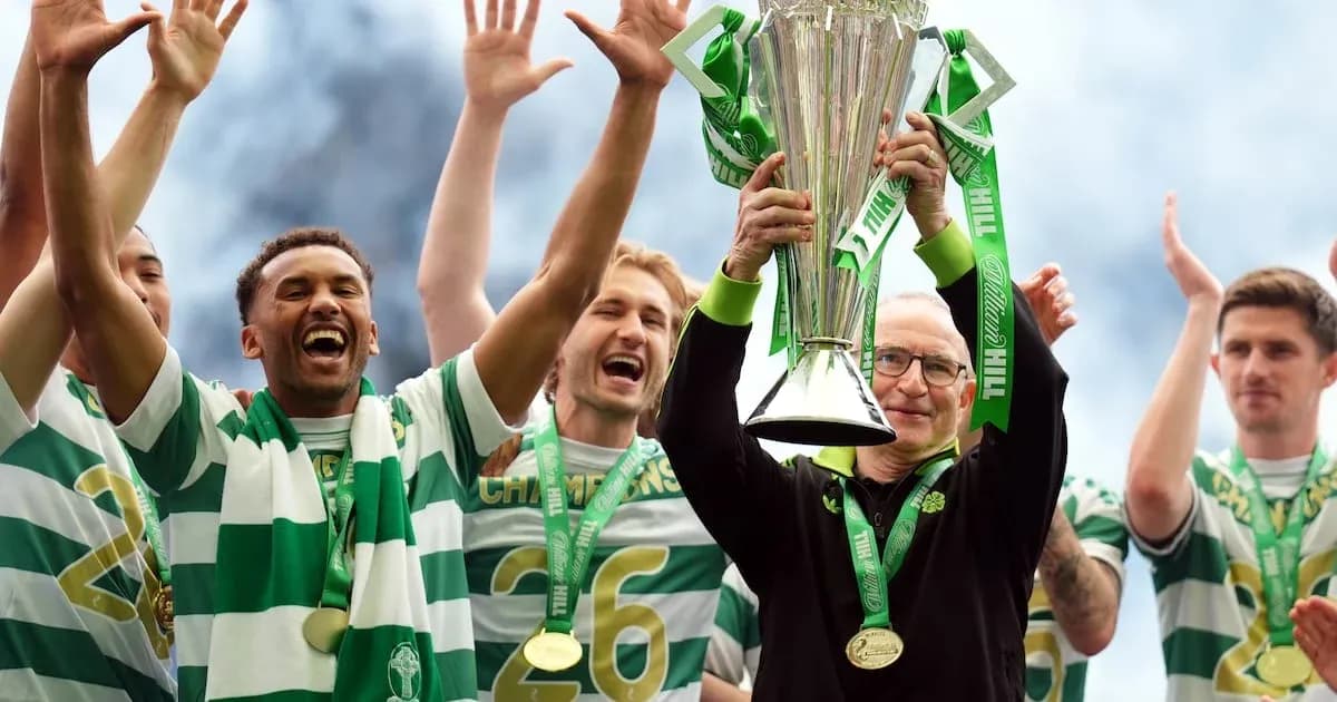 Celtic players celebrating with trophy after victory