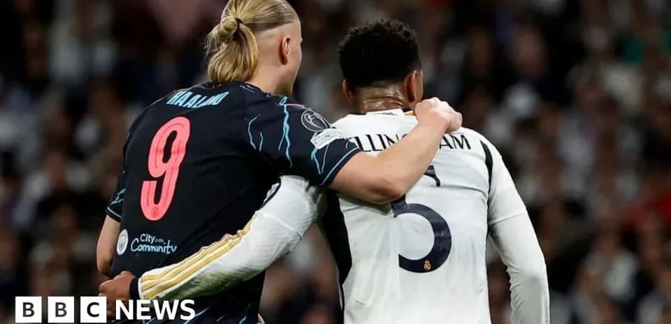 Two football players embracing on the pitch