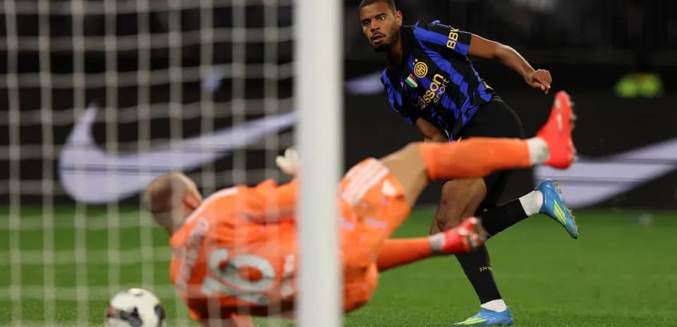 Player shooting on goal past diving goalkeeper