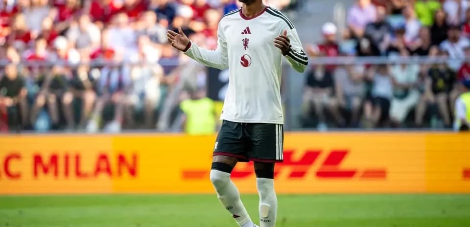 Player gesturing during match with crowd in background