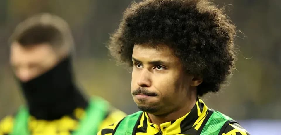 Player on bench wearing team colors and bib