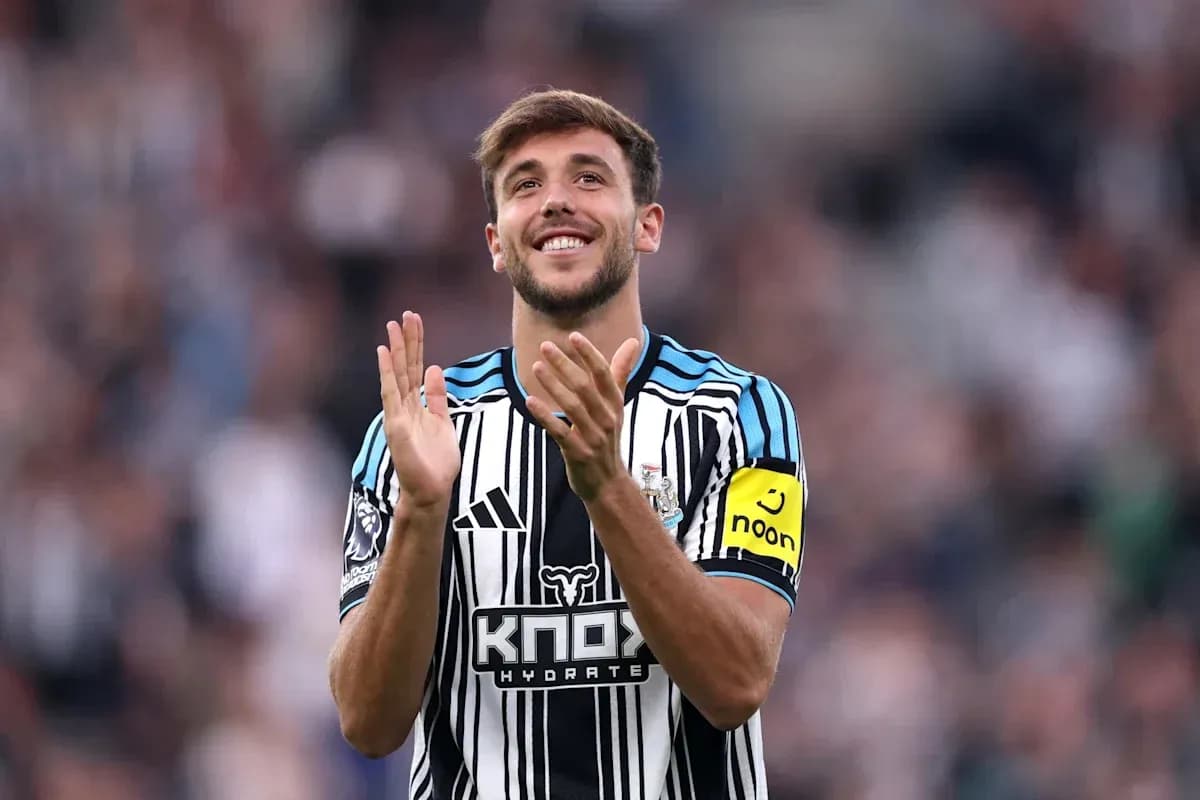 Newcastle player applauding fans during match