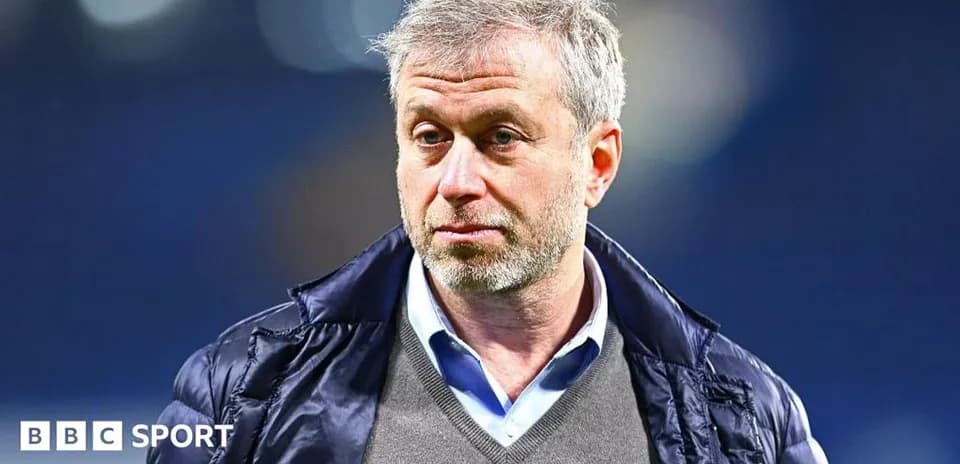 Man in jacket looking serious at event