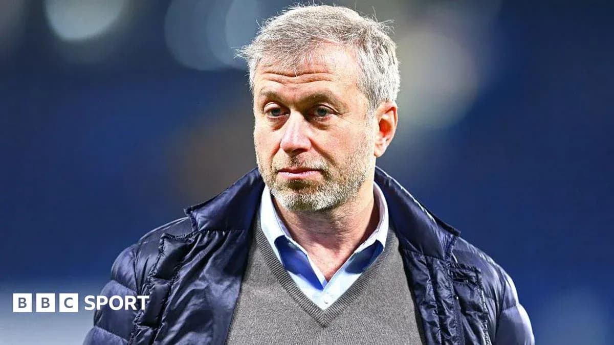 Man in jacket looking serious at event