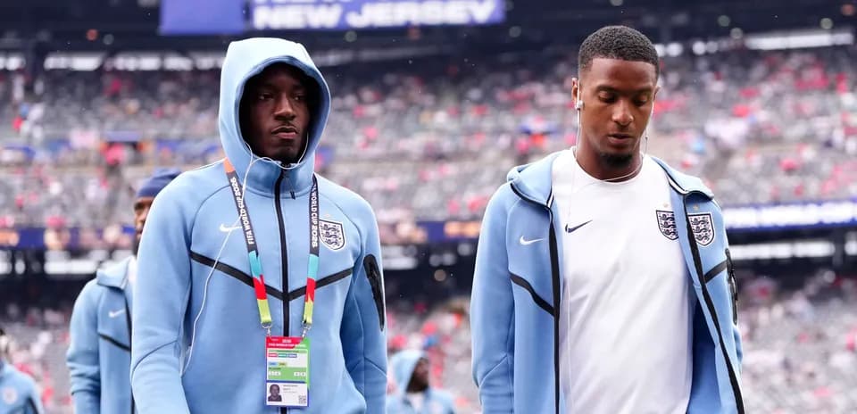 Two England players walking onto the field before match
