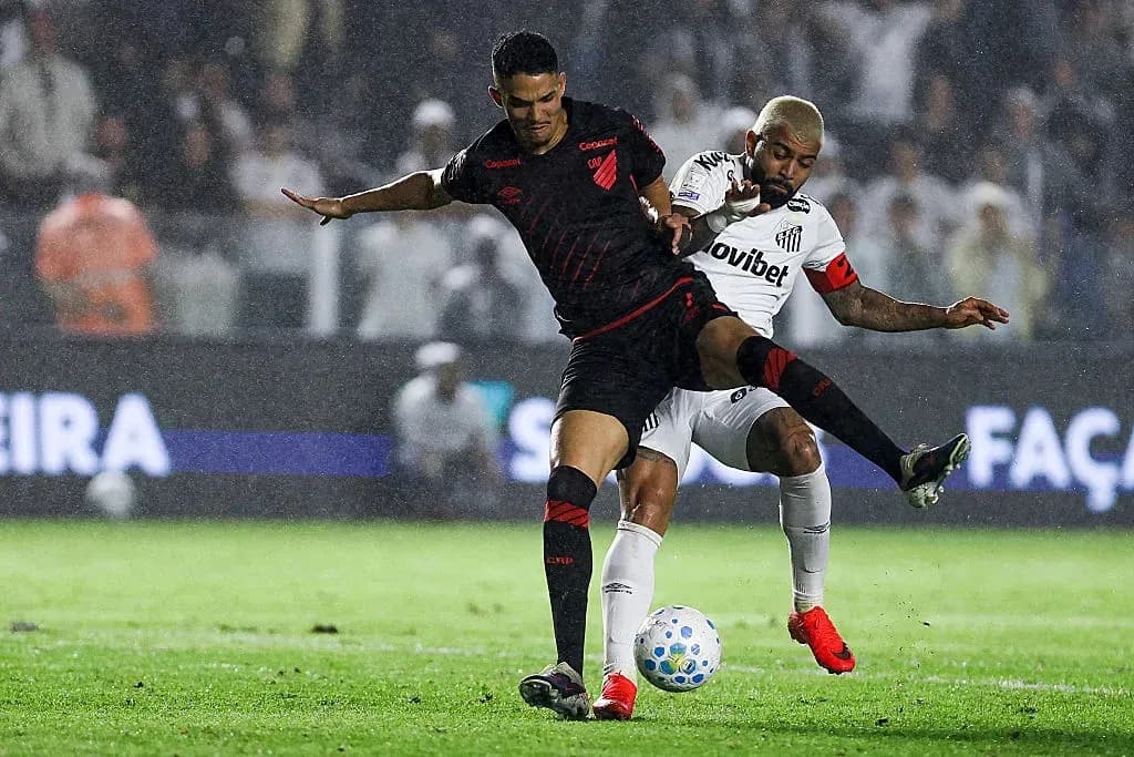 Players competing for the ball in rainy match