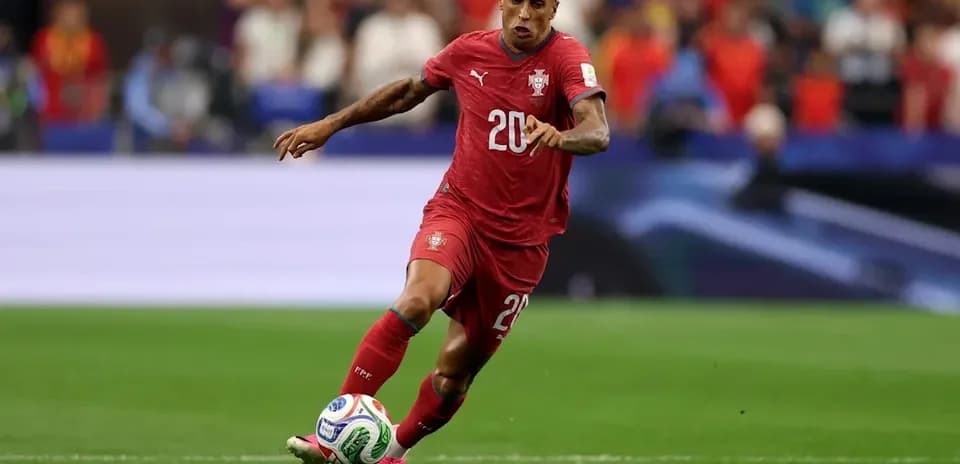 Player in red jersey sprinting with soccer ball