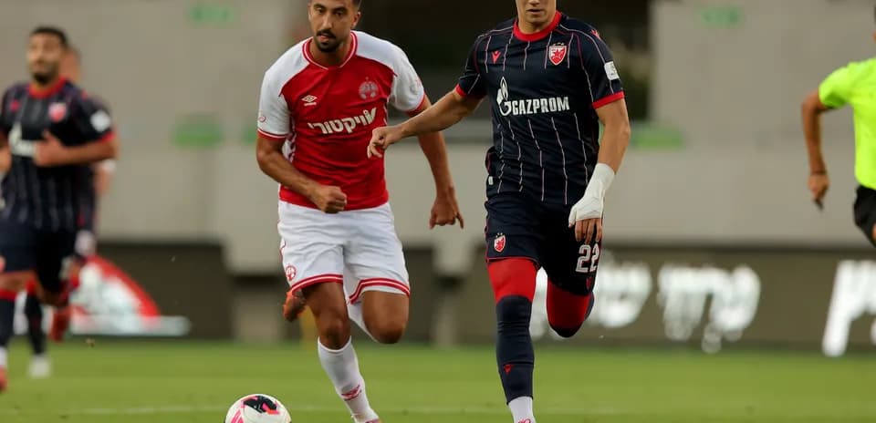 Crvena Zvezda player dribbling against Hapoel Beer Sheva