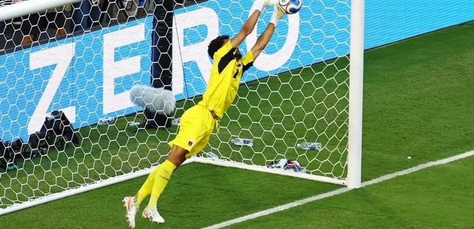 Goalkeeper diving to save a soccer shot