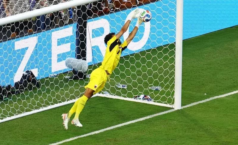 Goalkeeper diving to save a soccer shot