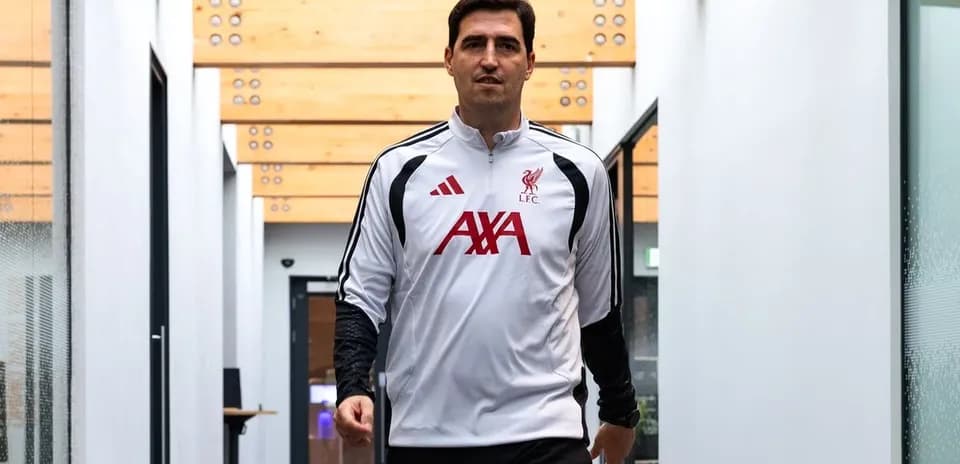 Goalkeeper walking through training facility hallway