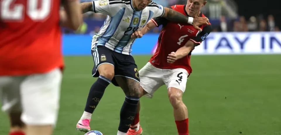 Argentinian player challenged by Austrian defender during match