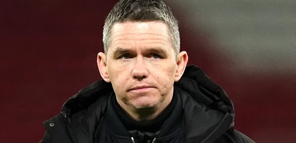 Coach looking serious on the sidelines during match