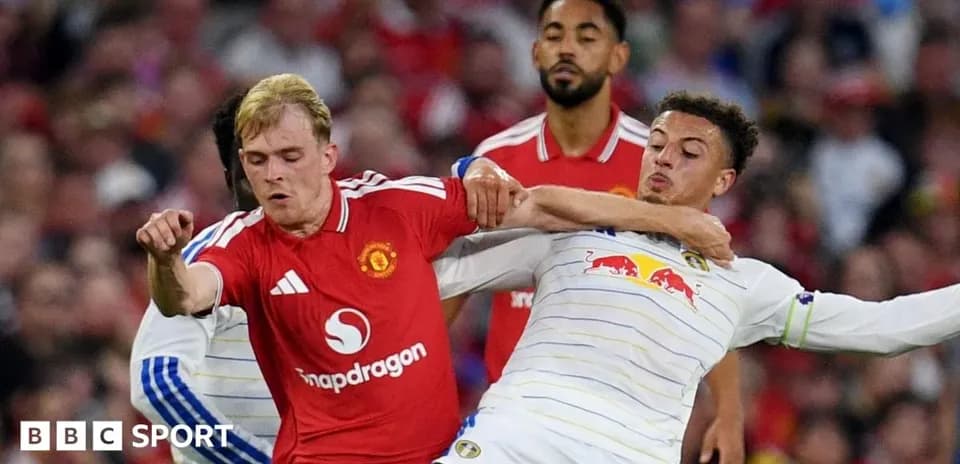 Two players in a tackle during a football match