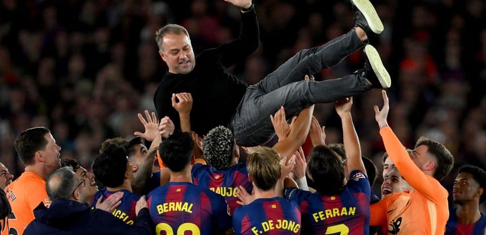 Team celebrating by lifting their coach in the air