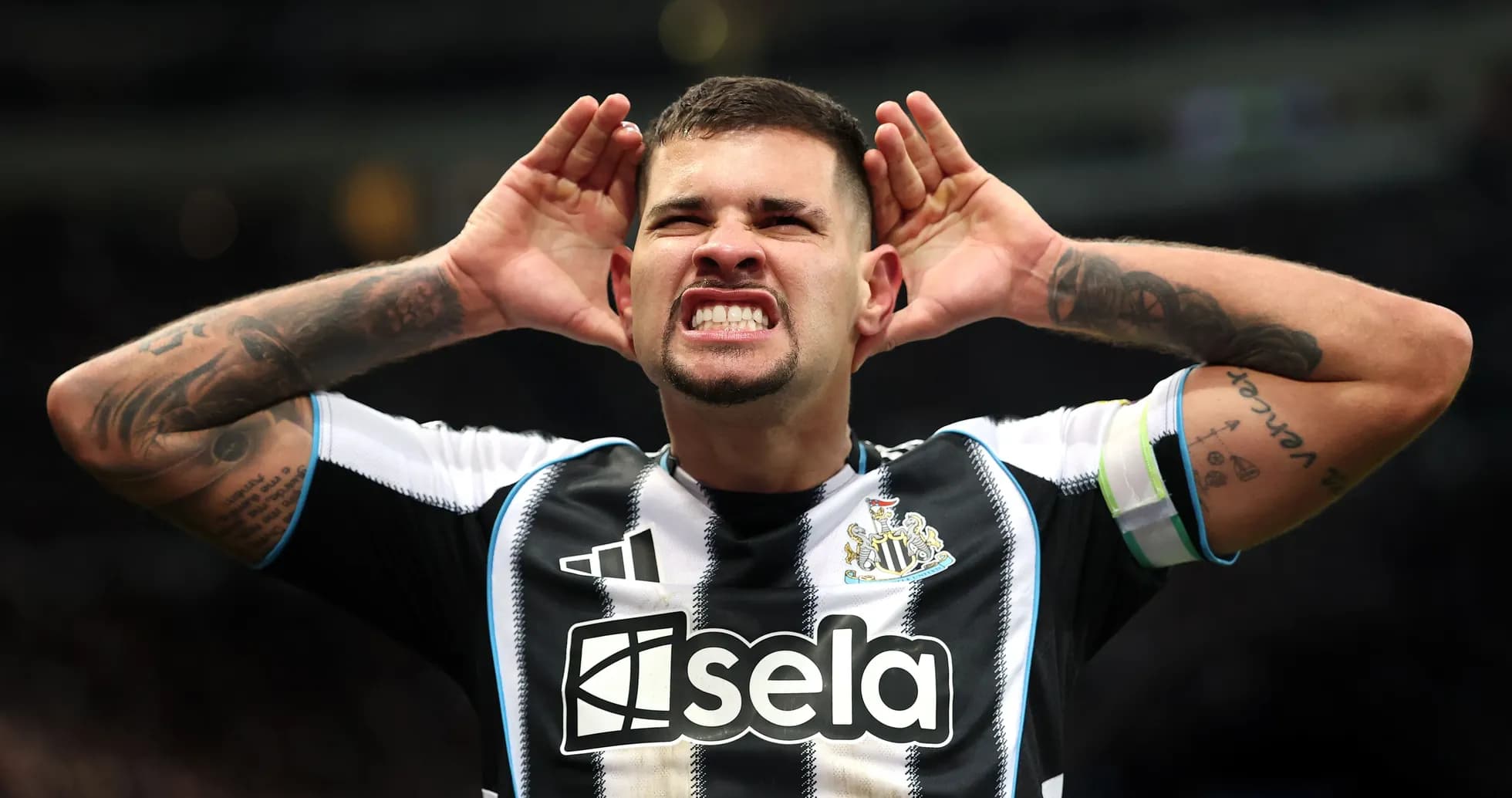Player celebrating with hands on ears after goal