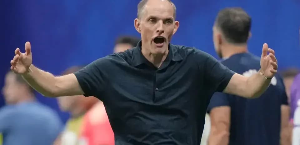 Coach gesturing animatedly on the sidelines during match