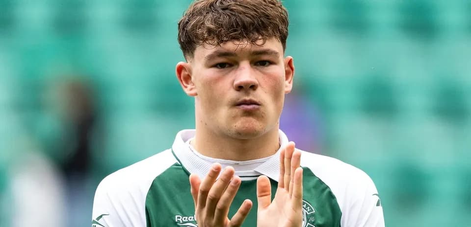 Player applauding fans in Hibernian jersey
