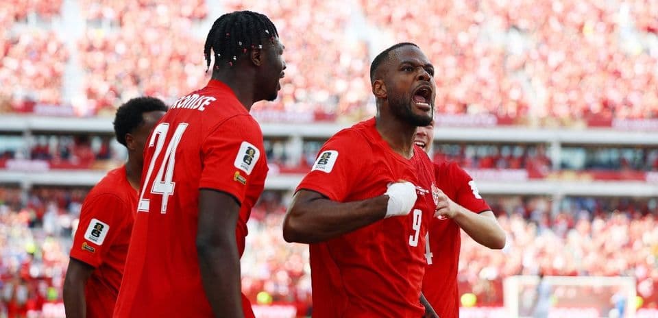 Players celebrating a goal during Canada match