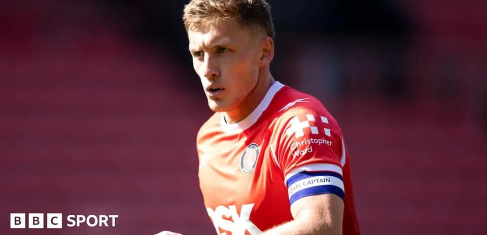 Player wearing red jersey with captain's armband