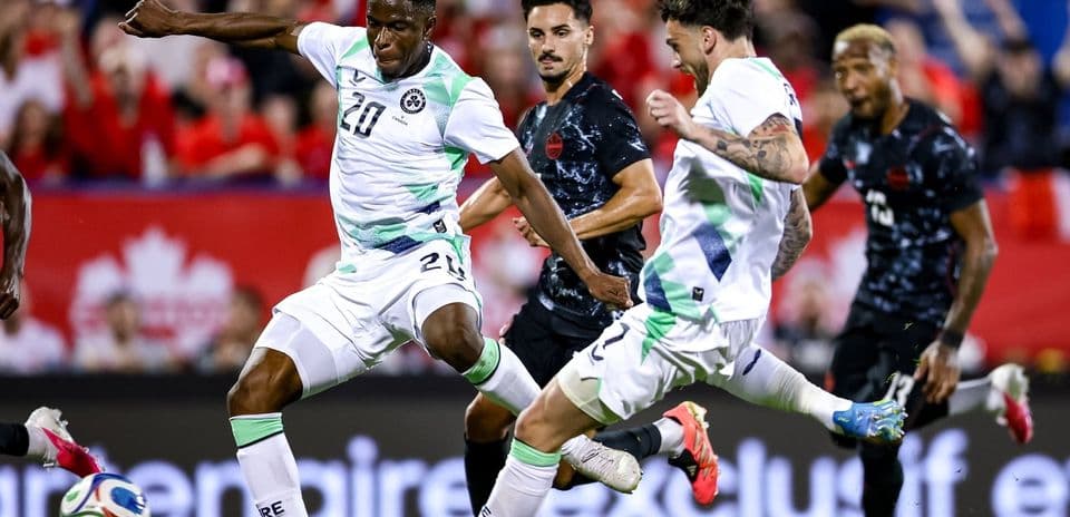 Players contesting the ball during a soccer match
