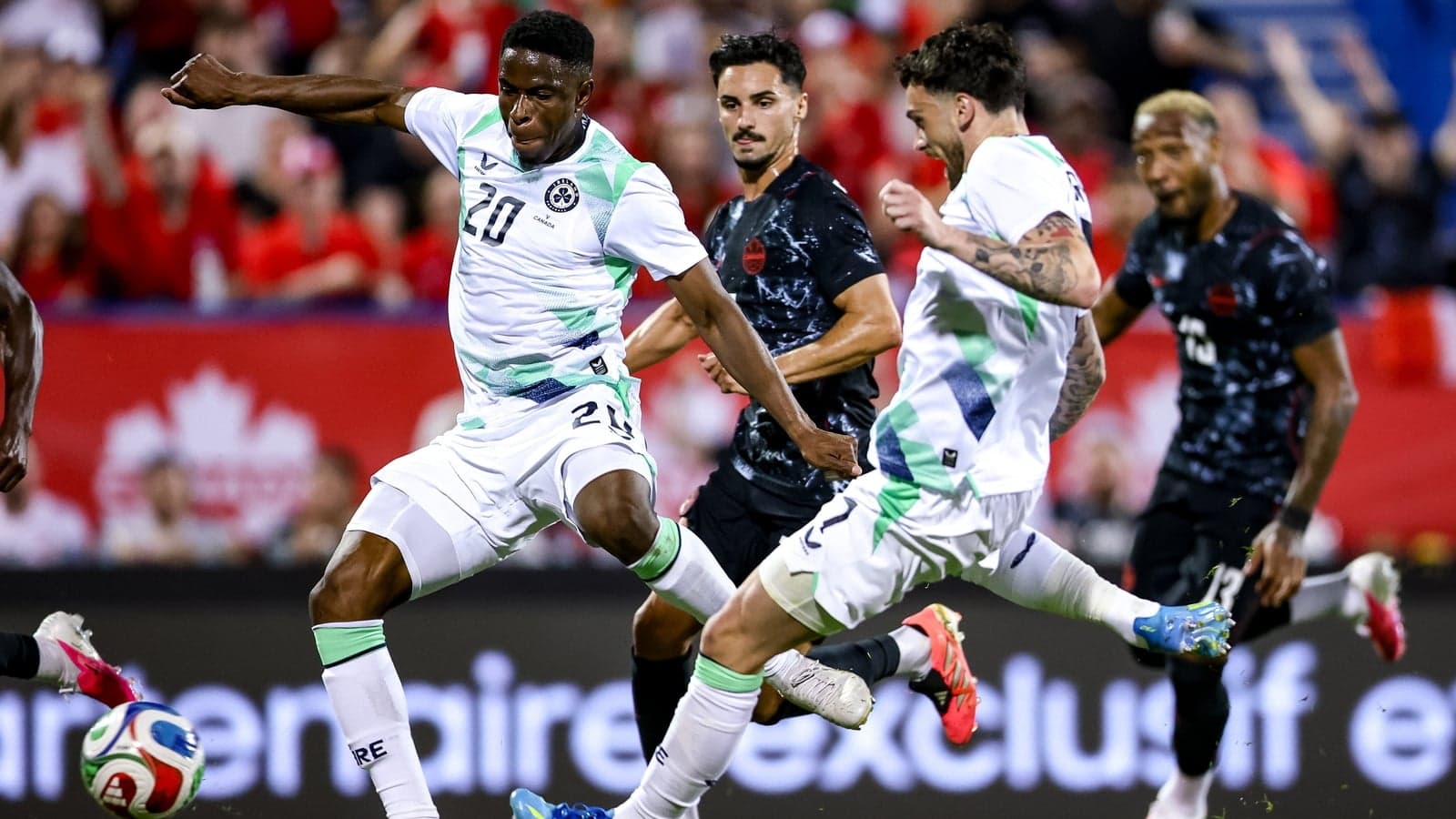Players contesting the ball during a soccer match