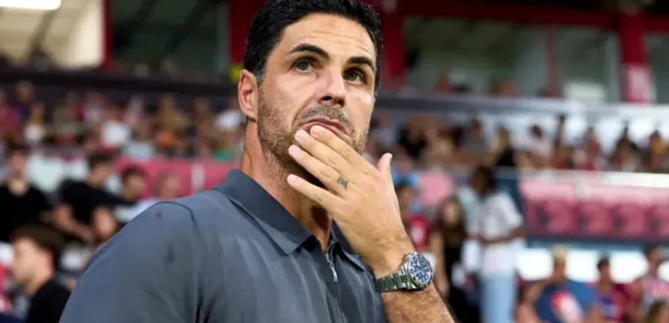 Coach observing the match with hand on chin