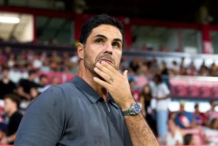 Coach observing the match with hand on chin