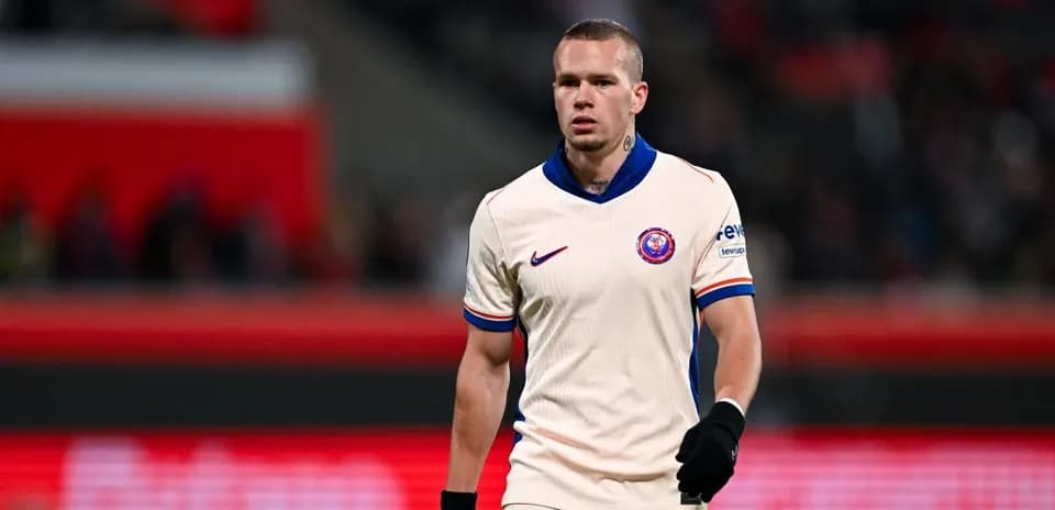 Player in cream jersey walking on the pitch