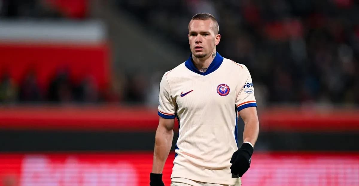 Player in cream jersey walking on the pitch