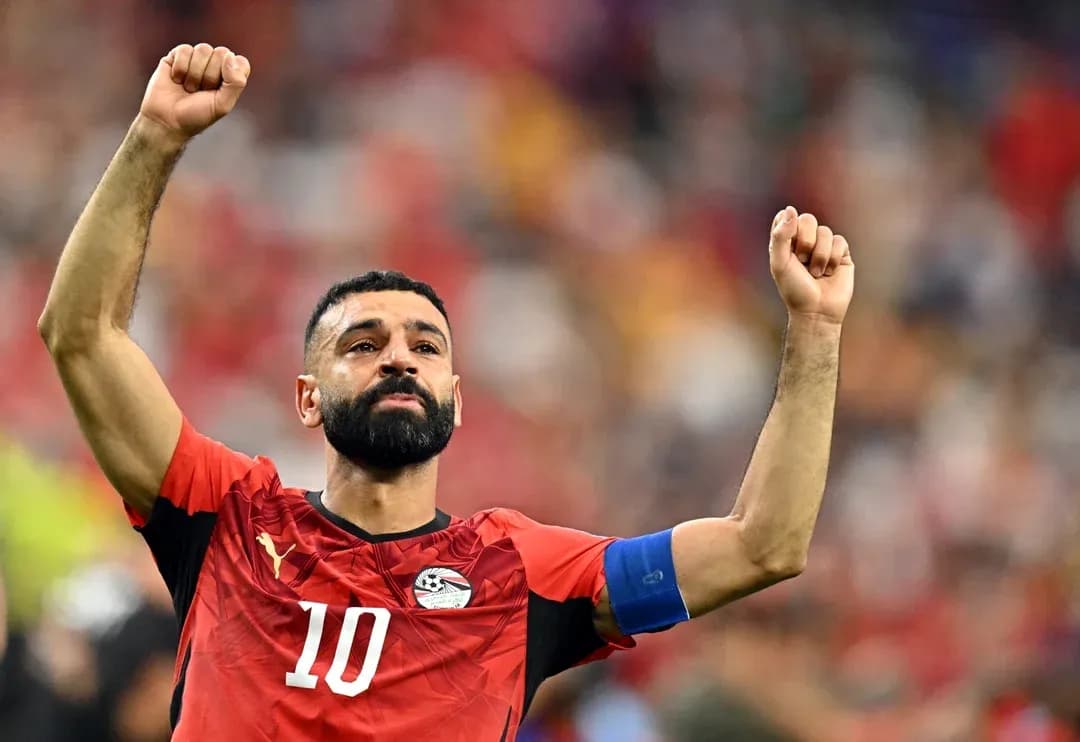 Player celebrating with raised arms in team jersey