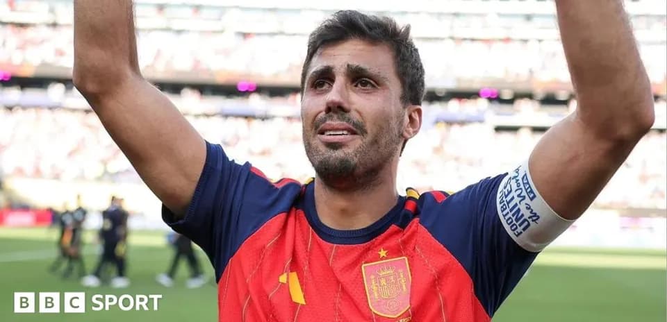 Football player celebrating with raised arms on field