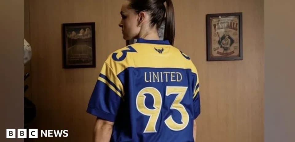 Person wearing a blue and yellow sports jersey