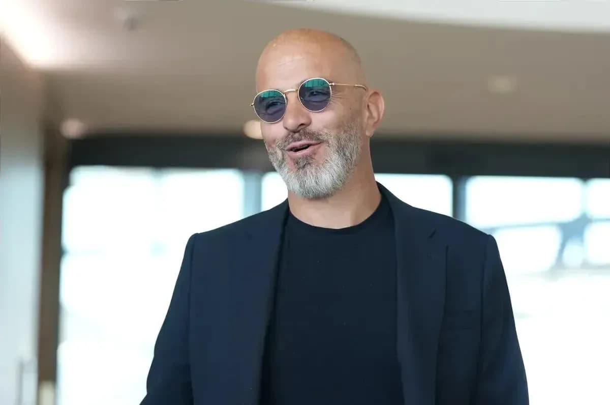 Man in sunglasses smiling in modern interior