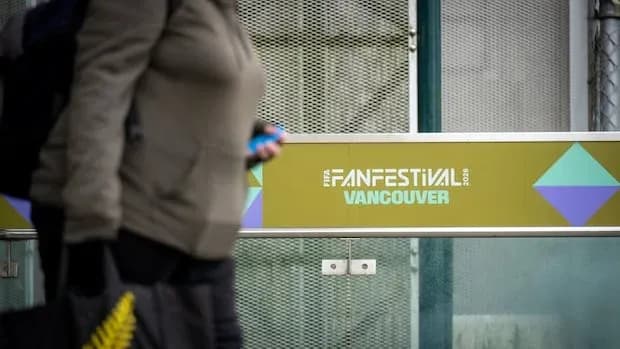 Person walking past Fan Festival sign in Vancouver