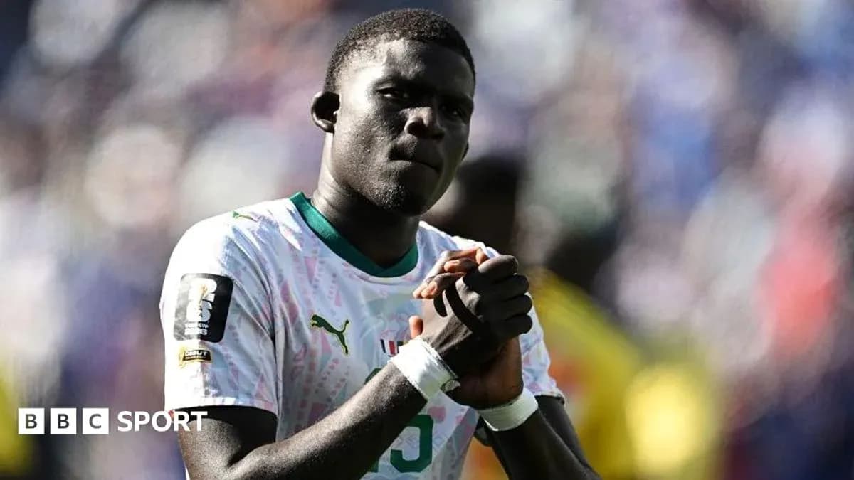 Player in national team jersey with clasped hands