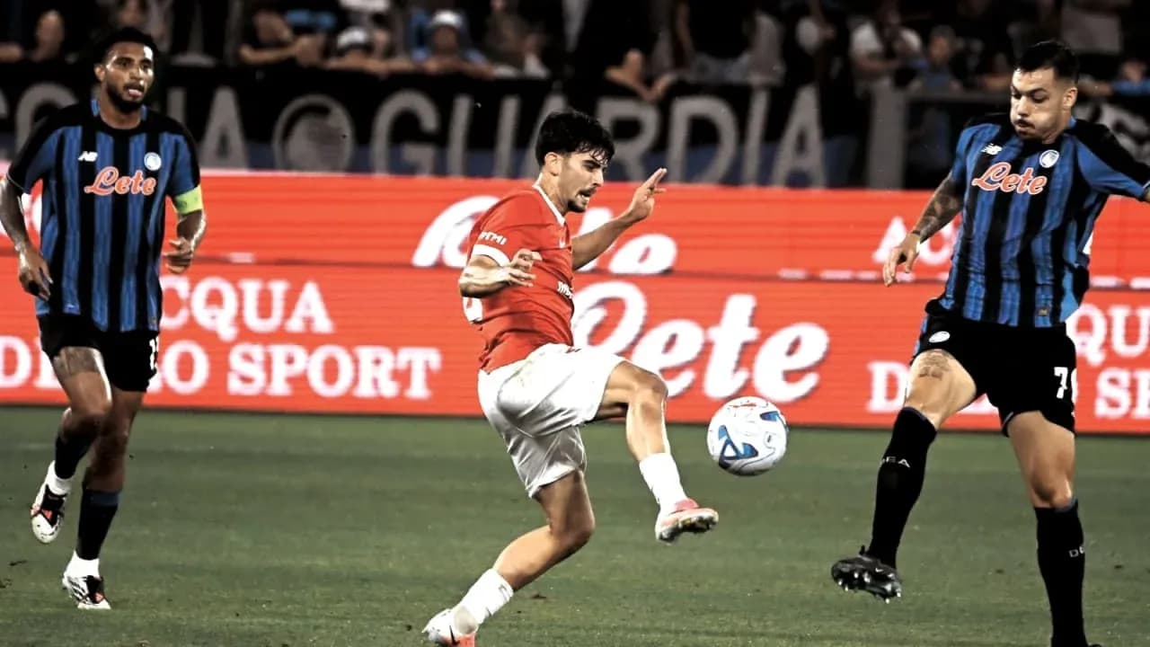 Player kicking ball during match with opponents nearby