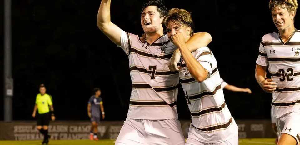 Lehigh players celebrating a goal on the field