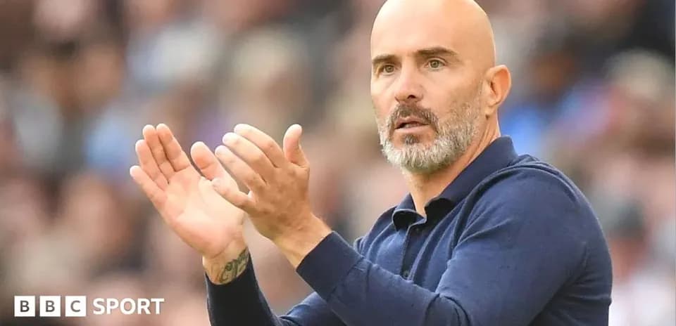 Coach applauding from the sidelines during match