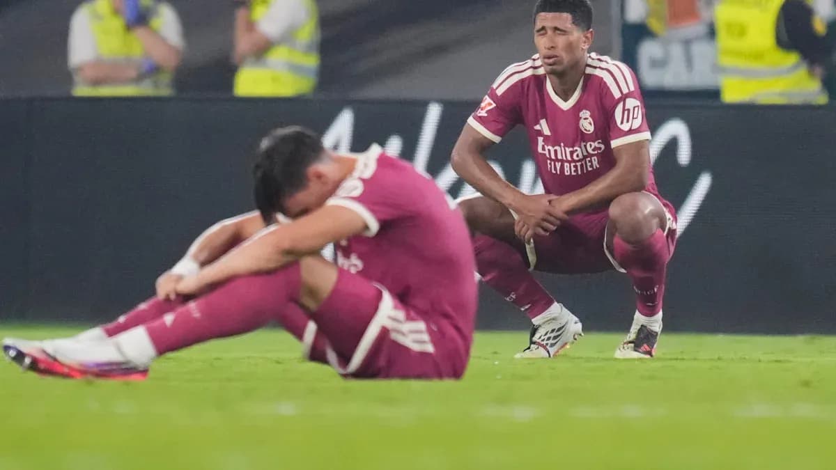 Real Madrid players sitting on the pitch after match