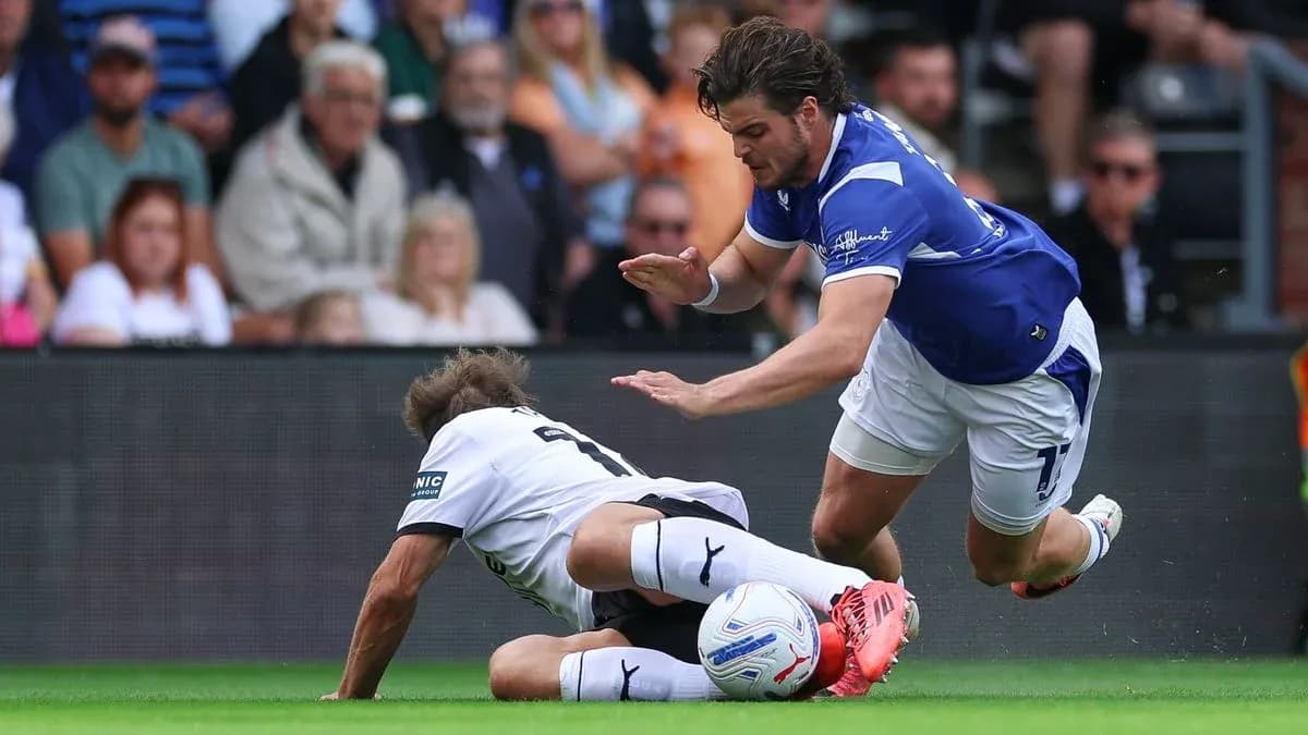 Player tackling opponent on the pitch during match