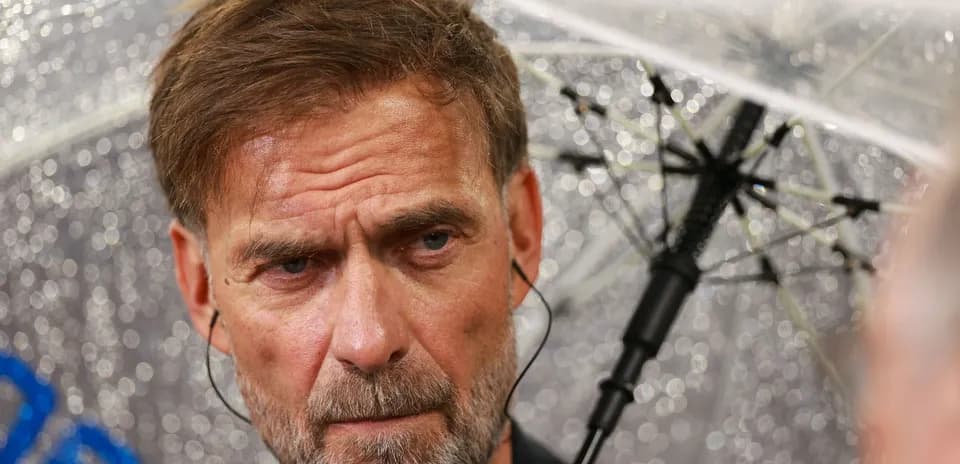 Man speaking under an umbrella in rainy weather