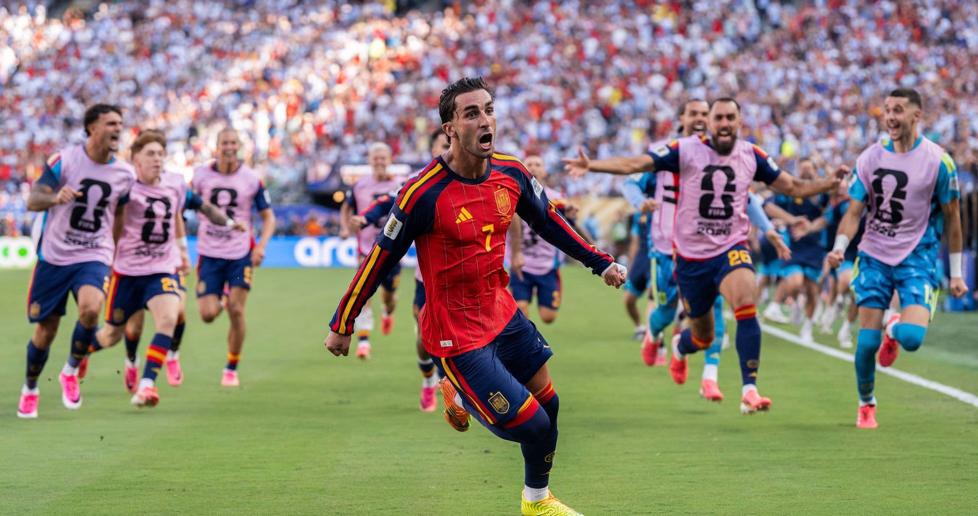 Spain player celebrating while teammates run behind