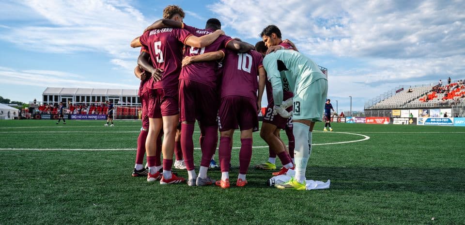 Players huddling before the match