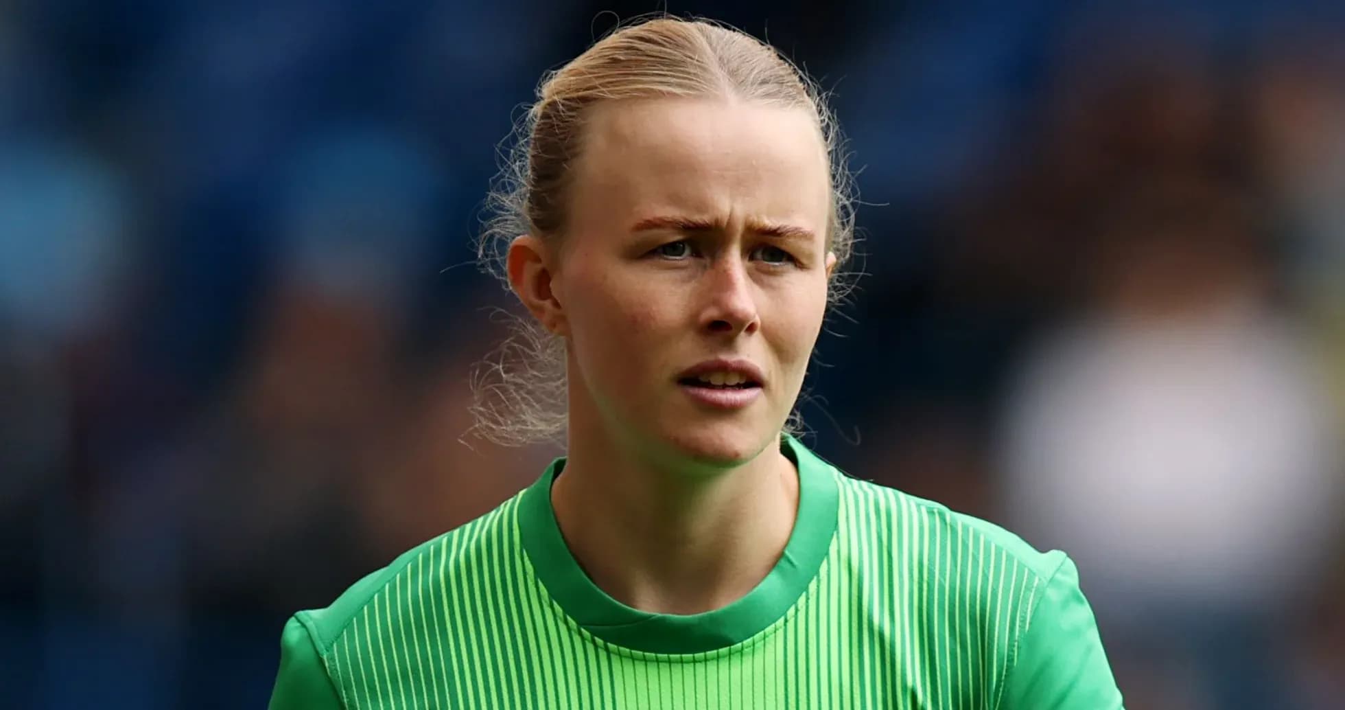 Goalkeeper in green jersey during match warm-up