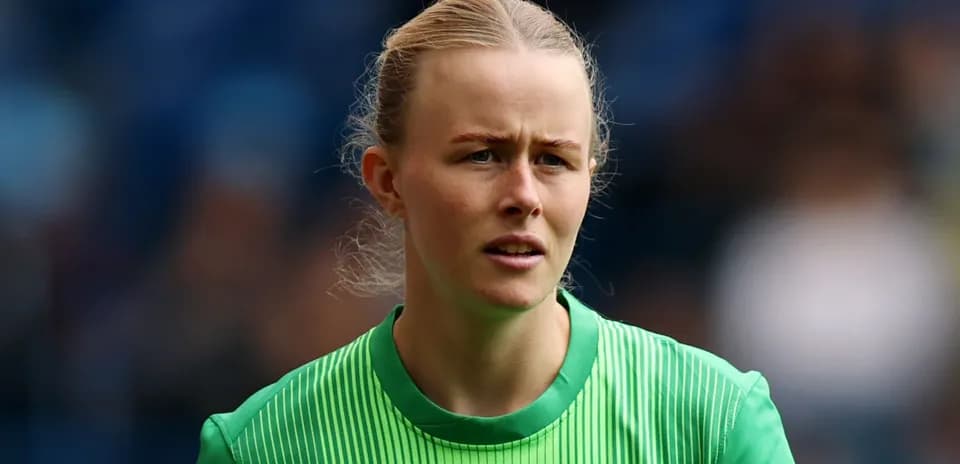 Goalkeeper in green jersey during match warm-up