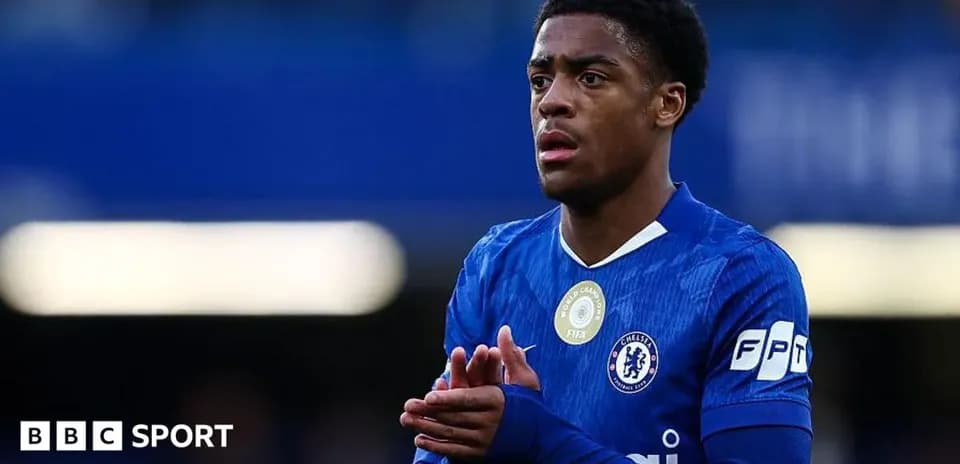 Player in blue Chelsea jersey looking thoughtful