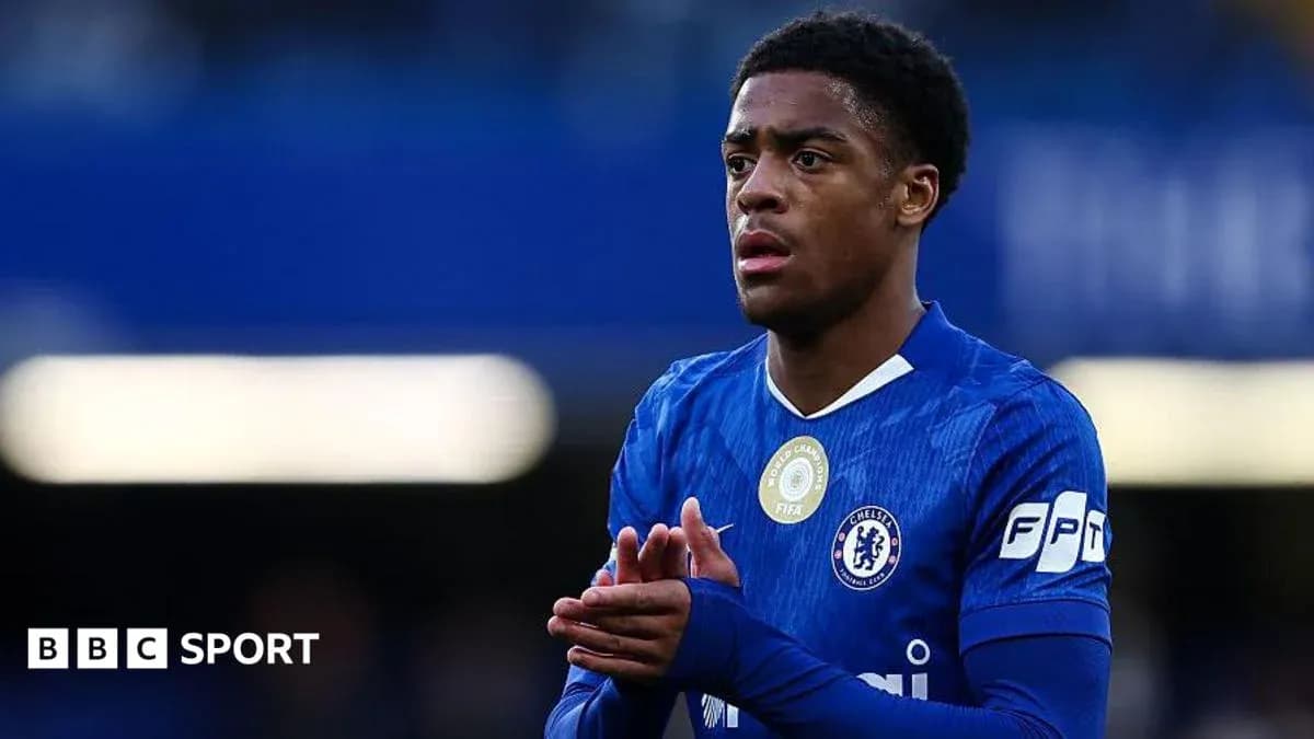 Player in blue Chelsea jersey looking thoughtful