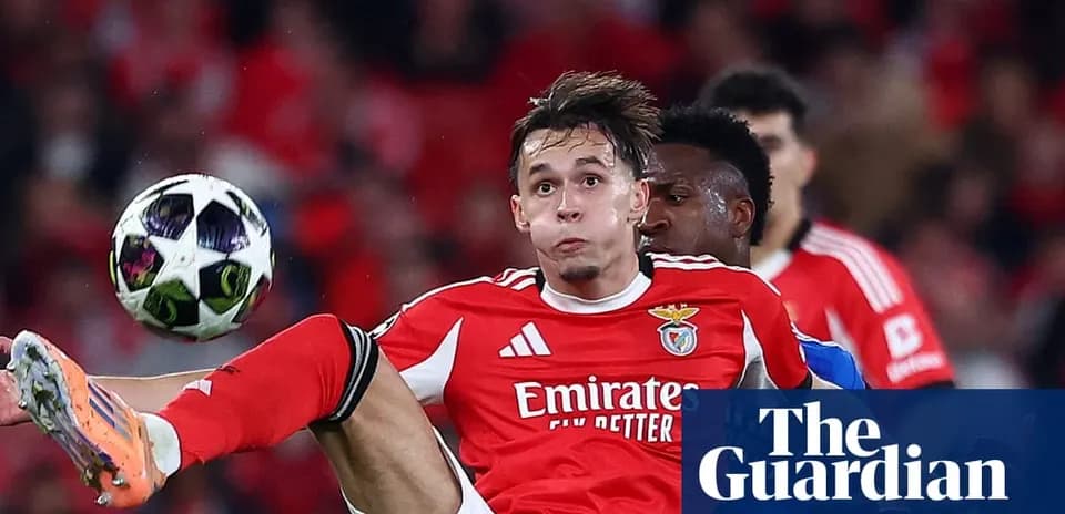 Benfica player in red jersey kicking ball during match