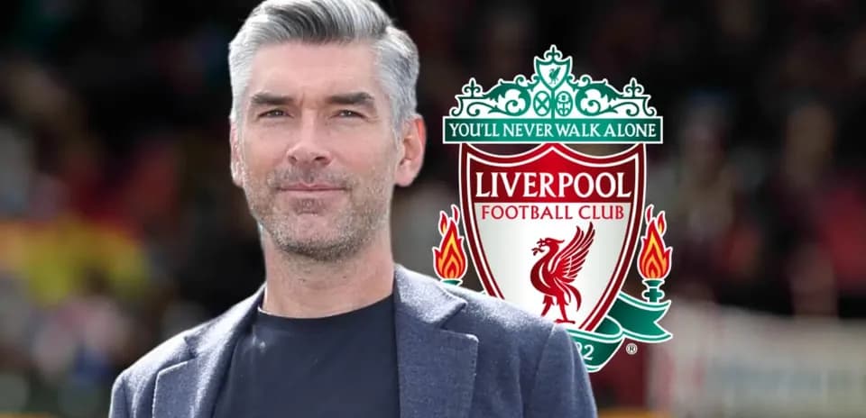Man in suit with Liverpool FC logo background